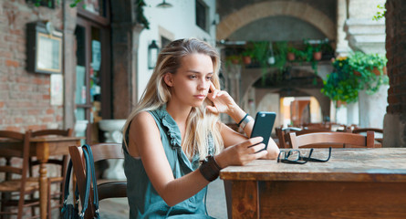 Blonde woman with smartphone