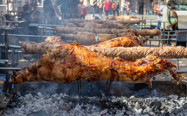 Greek Easter custom. Kokoretsi, kokorec and lamb, sheep, kid grilling on spits over charcoals fire.
