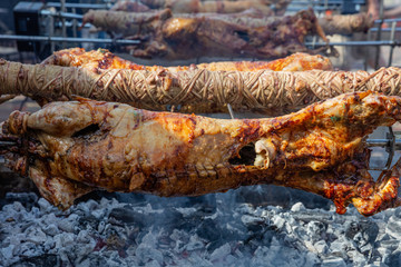 Greek Easter custom. Kokoretsi, kokorec and lamb, sheep, kid grilling on spits over charcoals fire.