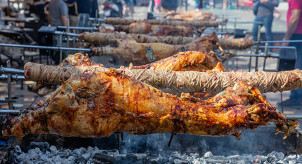 Greek Easter custom. Kokoretsi, kokorec and lamb, sheep, kid grilling on spits over charcoals fire.