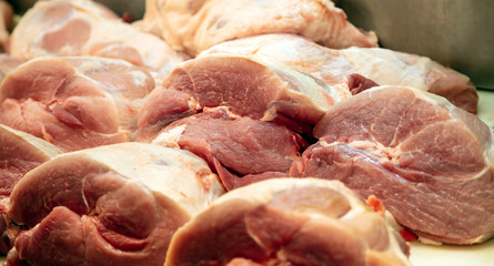 Meat concept. Raw pork in big pieces at butcher shop. Uncooked pig for background, closeup.
