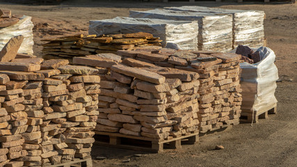 Pallets with natural facing stone and cobblestones