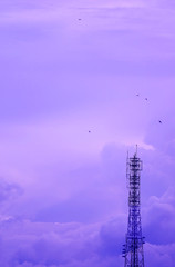 Pastel Purple Colored Telecommunication Tower Against Cloudy Sky