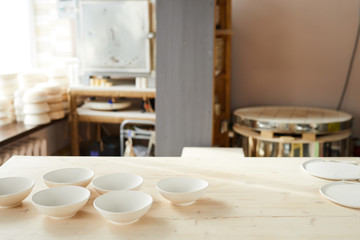 Background image of traditional pottery shop interior lit by sunlight, copy space
