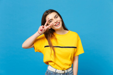 Portrait of cheerful attractive young woman in vivid casual clothes looking camera showing victory...