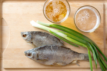 Russian snack . Beer, dried fish and onion
