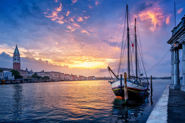 historic sailboat in venice against a sunrise