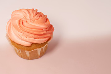 Homemade pink strawberry cupcake with butter cream.