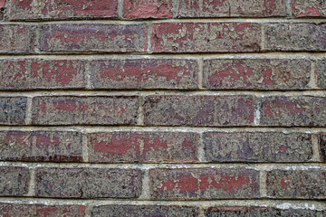 Old repaired weathered brick wall for background