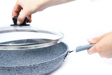 Fototapeta na wymiar Stylish frying pan in hands on a white background