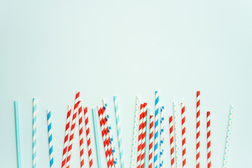 Colorful drinking straws for beverage on a bright background. Birthday festive cheerful background.