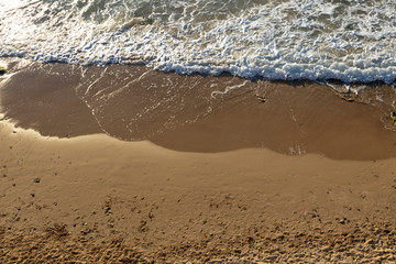 Sea surf, yellow sand, waves