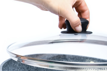Stylish frying pan in hands on a white background