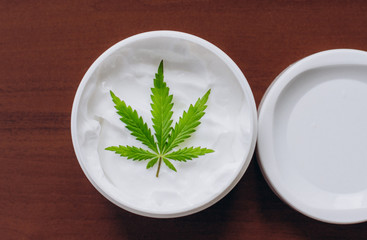 Cosmetic cream made of natural cannabis, hemp, moisturizing lotion with CBD content. Copy space for your design use,text