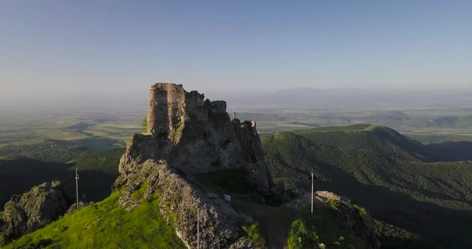 Beautiful Castle On Top Of A Mountain Surrounded By Trees and mountains while sunrise early monring