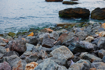 sea landscape at sunset, stone coast and beautiful sky
