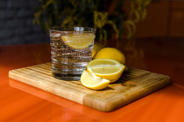 Citrus fizzy lemonade, a glass of water with slices of lemon to quench your thirst on the Board on...