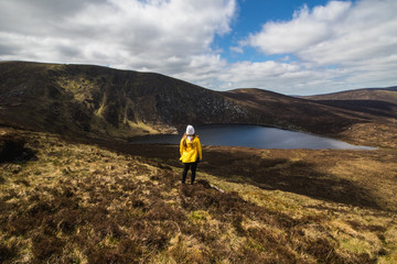 Person in Yellow Raincoat looking at Lough Ouler in Wicklow Mountains