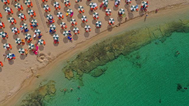Aerial drone top view photo of turquoise organised beach forming a small heart shaped lagoon and mountainous seascape of Stavros, Chania, Crete island, Greece