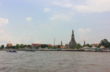 Fototapeta na wymiar Distant view of Buddhist temple of Wat Arun Ratchawararam or Temple of Dawn in Bangkok.