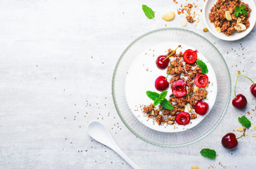 Yogurt with Cherries, Granola and Chia Seeds over Bright Background