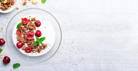Yogurt with Cherries, Granola and Chia Seeds over Bright Background