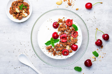 Yogurt with Cherries, Granola and Chia Seeds over Bright Background