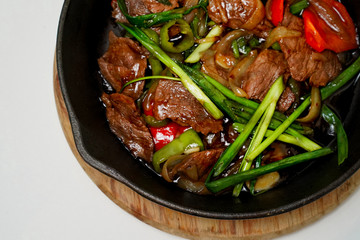 frying pan with meat and vegetables