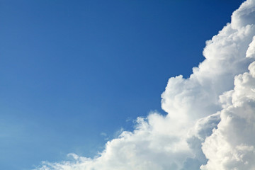 Naklejka na ściany i meble A huge cumulus and cumulonimbus clouds on the blue sky background