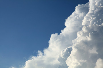 A huge cumulus and cumulonimbus clouds on the blue sky background