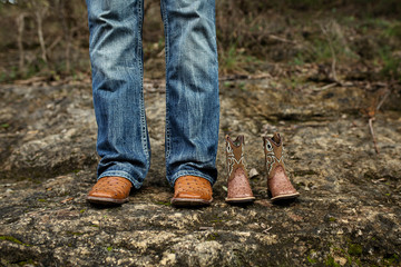 New Dad with Baby Cowboy Boots in Jeans