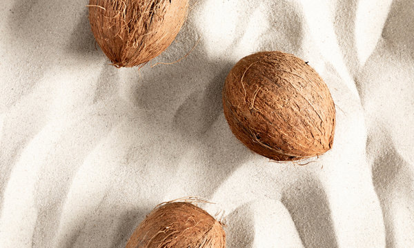 Summer Composition With Coconut. Concept  Beach Holiday. Coconut On Sand Background. Flat Lay, Top View, Copy Space