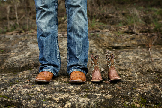 New Dad With Baby Cowboy Boots In Jeans