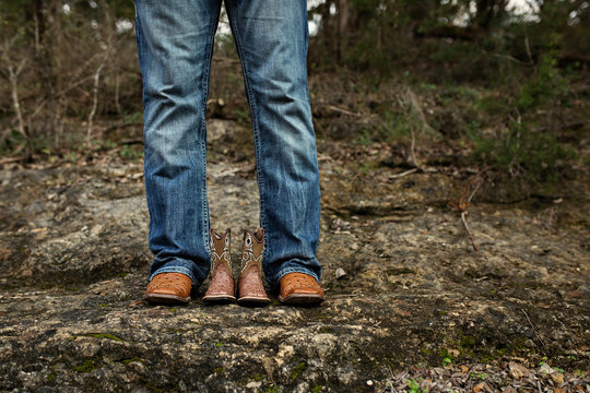 New Dad With Baby Cowboy Boots In Jeans