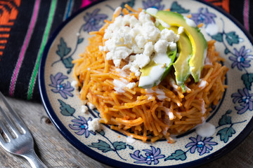 Mexican fideos dry soup with avocado and cheese