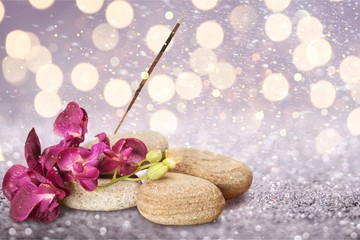 Zen basalt stones and flowers on white background