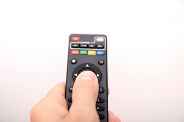 Fototapeta premium Hand pressing remote control isolated on white background.