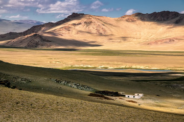 Dramatic sunset clouds above mountains and Mongolian steppe. South of Olgii in western Mongolia. The photo does not contain posterization or noise. These are stormy clouds colored by sunset   
