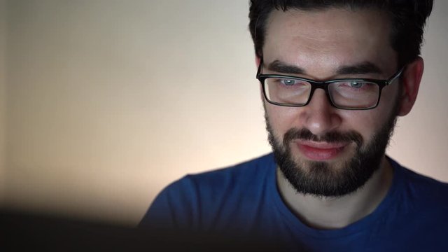 Young tired computer programmer working out new social net sitting at home