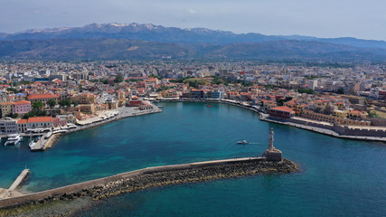 Aerial drone panoramic view of iconic and picturesque Venetian old port of Chania with famous landmark lighthouse and traditional character, Crete island, Greece