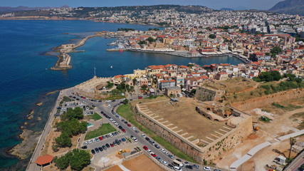 Aerial drone panoramic view of iconic and picturesque Venetian old port of Chania with famous landmark lighthouse and traditional character, Crete island, Greece