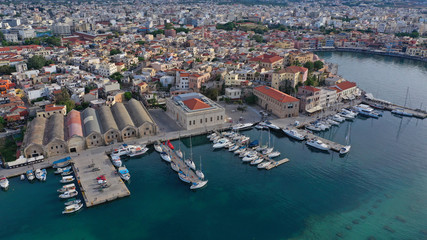 Obraz premium Aerial drone panoramic view of iconic and picturesque Venetian old port of Chania with famous landmark lighthouse and traditional character, Crete island, Greece