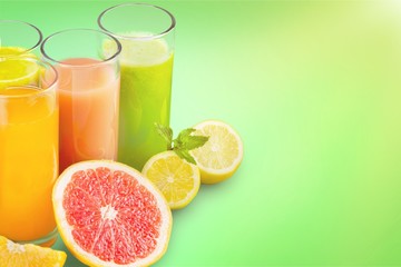 Tasty fruits  and juice with vitamins on background