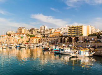 heraklion city old port view. clear day calm water boats and sky reflection on the sea beautiful colors