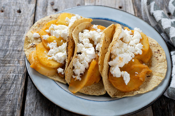 Mexican potato stew tacos with fresh cheese