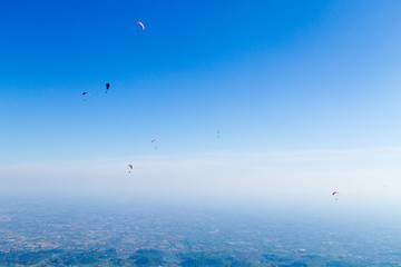 Paraglider on blue sky, Borso del Grappa, Italy