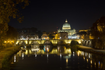 Fototapeta na wymiar Night scene of Rome, Tevere river with basilica in background