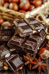 Hazelnut and almond milk and dark chocolate pieces tower.Chocolate bar pieces. Sweet food photo concept. The chunks of broken chocolate