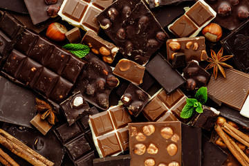 Chocolate on dark stone background. Top view with copy space