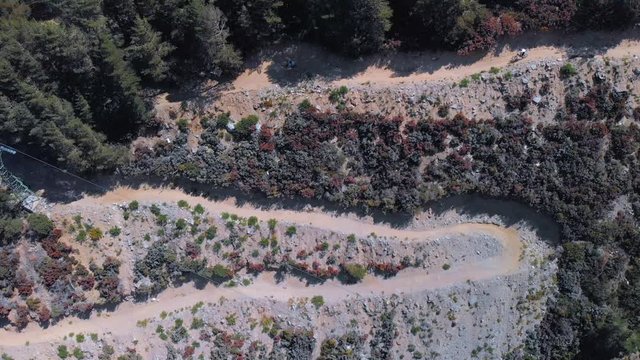 group of downhill riders going down a track in a bike park